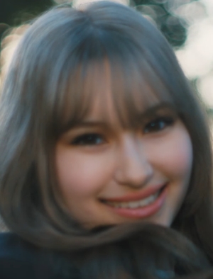 A close-up screenshot of Emi in the new music video