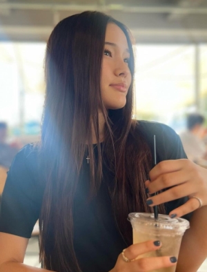 Michelle sitting and eating in a restaurant